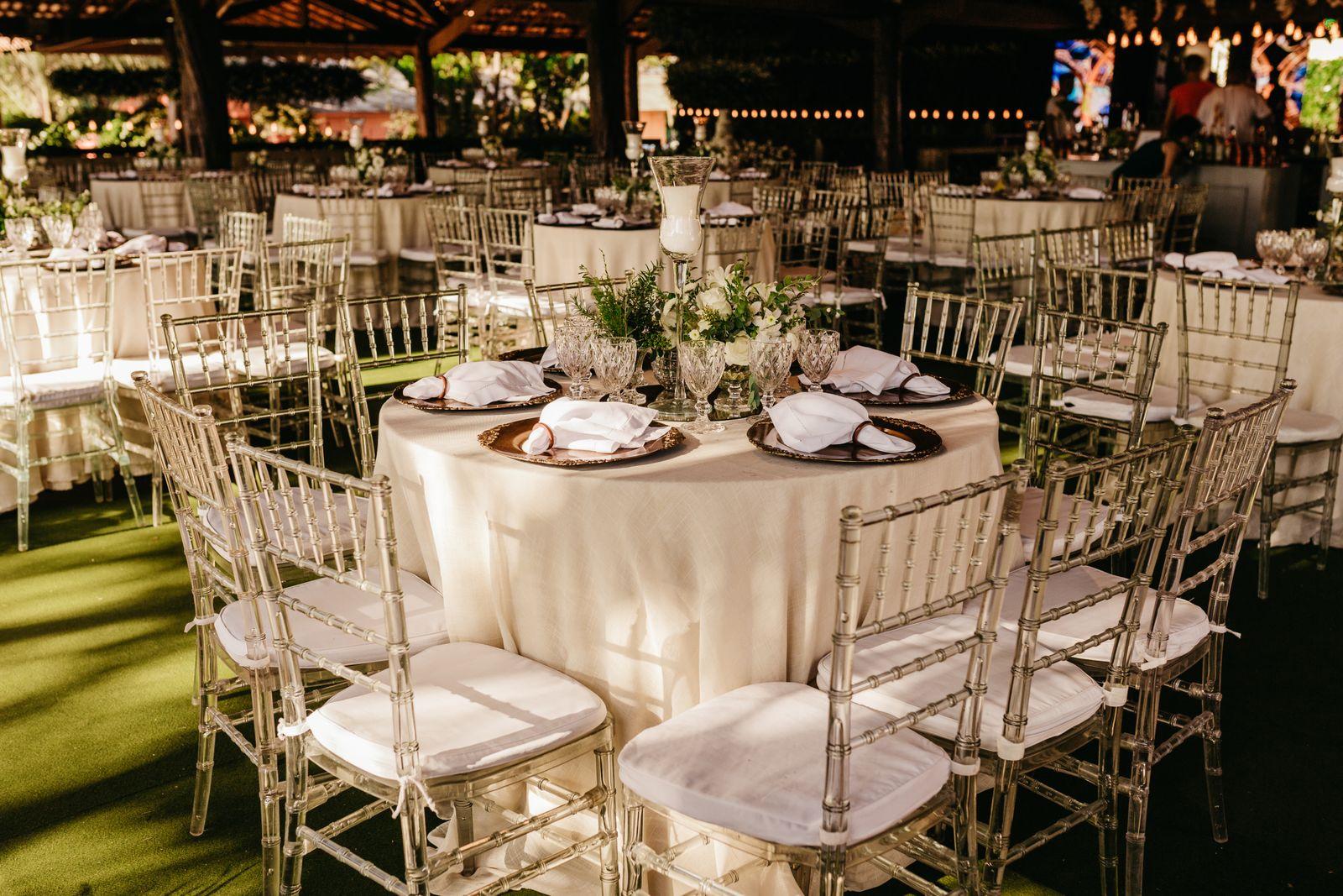 Reception tables with clear chairs and florals